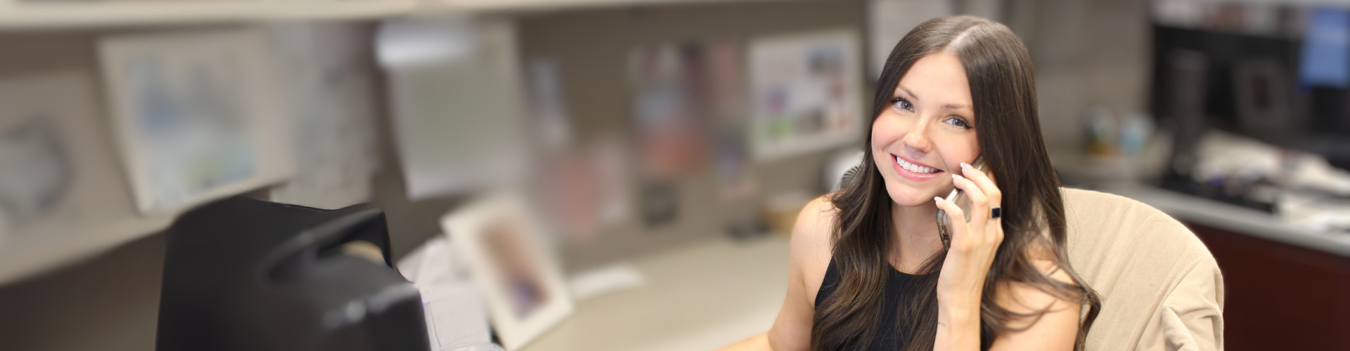 Photo of Falcon, an Account Executive at Agile, sitting at her desk on a sales call.