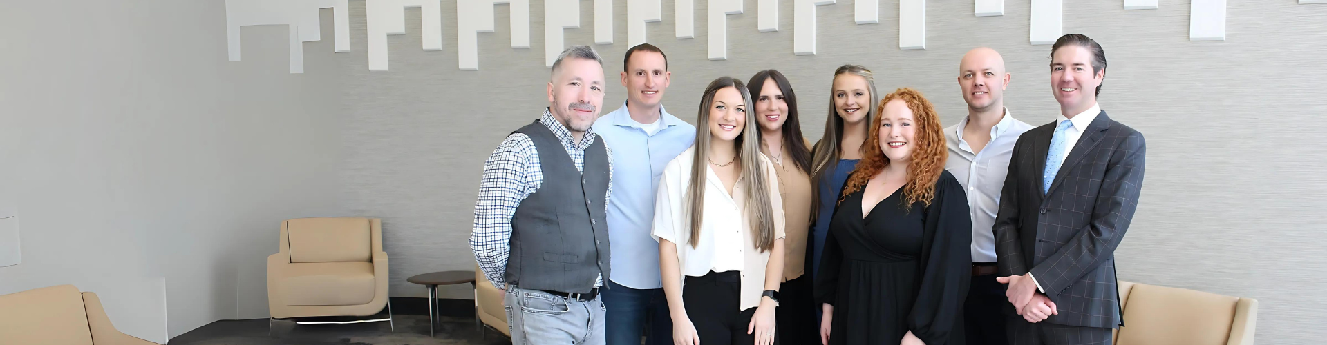 Photo of the Atlanta Agile Recruiting team, all dressed professional in a modern office. Form left to right, Ben, Justin, Alissa, Lexi, Emily, Anna, Adam, then Bric.