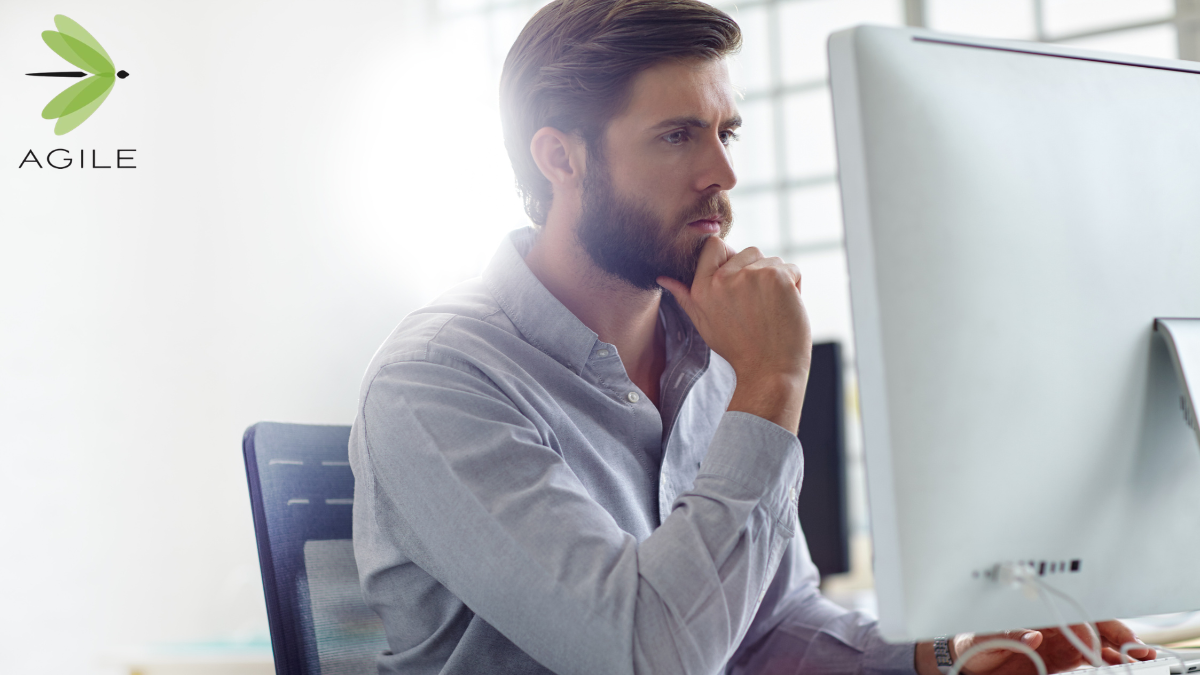 Technology professional evaluating contract vs direct hire IT job opportunities at a desktop computer
